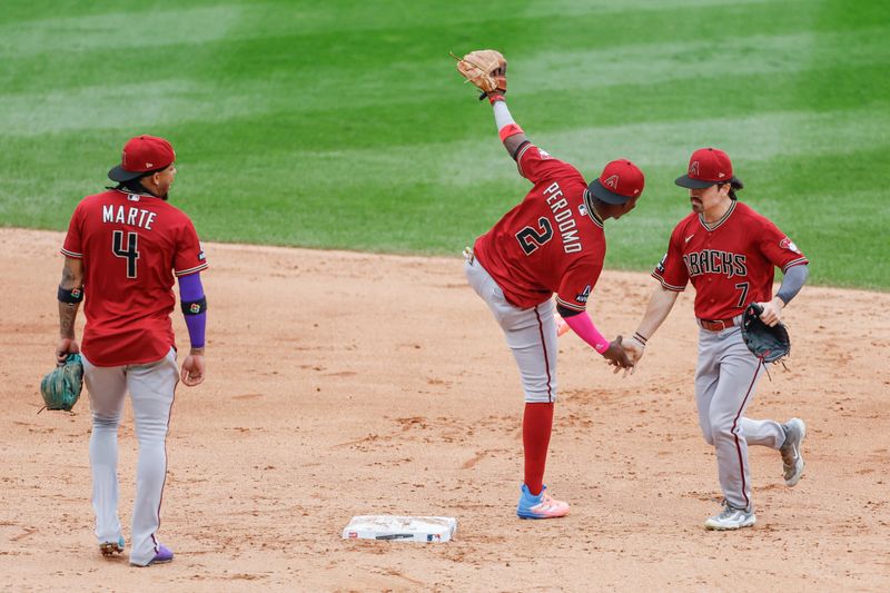 Sep 27, 2023; Chicago, Illinois, USA; Arizona Diamondbacks shortstop Geraldo Perdomo (2) and left fielder Corbin Carroll (7) celebrate the teams win against the Chicago White Sox at Guaranteed Rate Field. Mandatory Credit: Kamil Krzaczynski-USA TODAY Sports