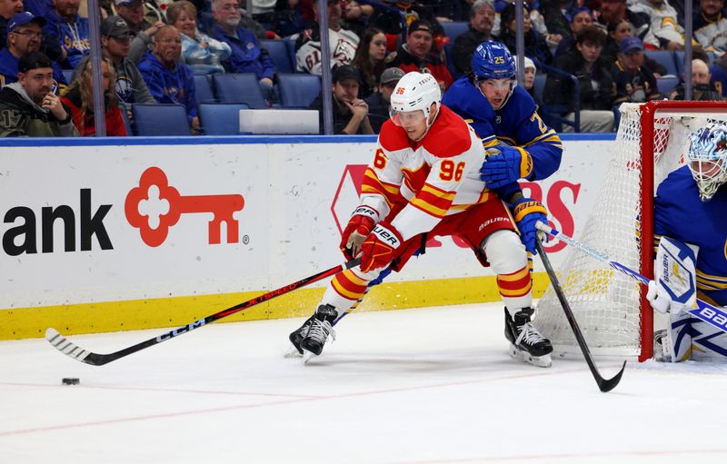 Nov 9, 2024; Buffalo, New York, USA;  Calgary Flames left wing Andrei Kuzmenko (96) controls the puck as Buffalo Sabres defenseman Owen Power (25) tries to defend during the first period at KeyBank Center. Mandatory Credit: Timothy T. Ludwig-Imagn Images