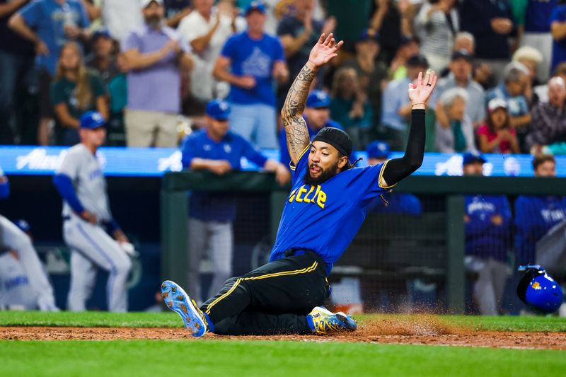 Aug 25, 2023; Seattle, Washington, USA; Seattle Mariners shortstop J.P. Crawford (3) slides home to score a run against the Kansas City Royals during the fourth inning at T-Mobile Park. Mandatory Credit: Joe Nicholson-USA TODAY Sports