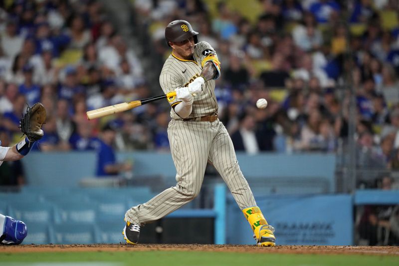 Sep 11, 2023; Los Angeles, California, USA; San Diego Padres designated hitter Manny Machado (13) hits a home run in the sixth inning against the Los Angeles Dodgers at Dodger Stadium. Mandatory Credit: Kirby Lee-USA TODAY Sports