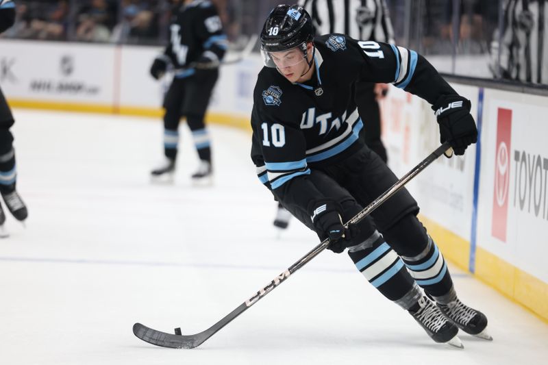 Nov 13, 2024; Salt Lake City, Utah, USA; Utah Hockey Club defenseman Maveric Lamoureux (10) skates with the puck against against the Carolina Hurricanes during the first period at Delta Center. Mandatory Credit: Rob Gray-Imagn Images