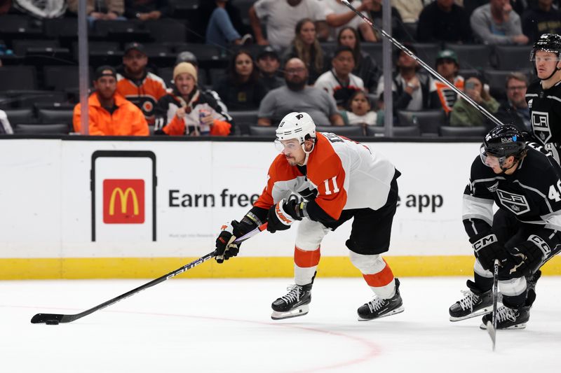 Nov 11, 2023; Los Angeles, California, USA;  Philadelphia Flyers right wing Travis Konecny (11) controls the puck against Los Angeles Kings center Blake Lizotte (46) during the third period at Crypto.com Arena. Mandatory Credit: Kiyoshi Mio-USA TODAY Sports