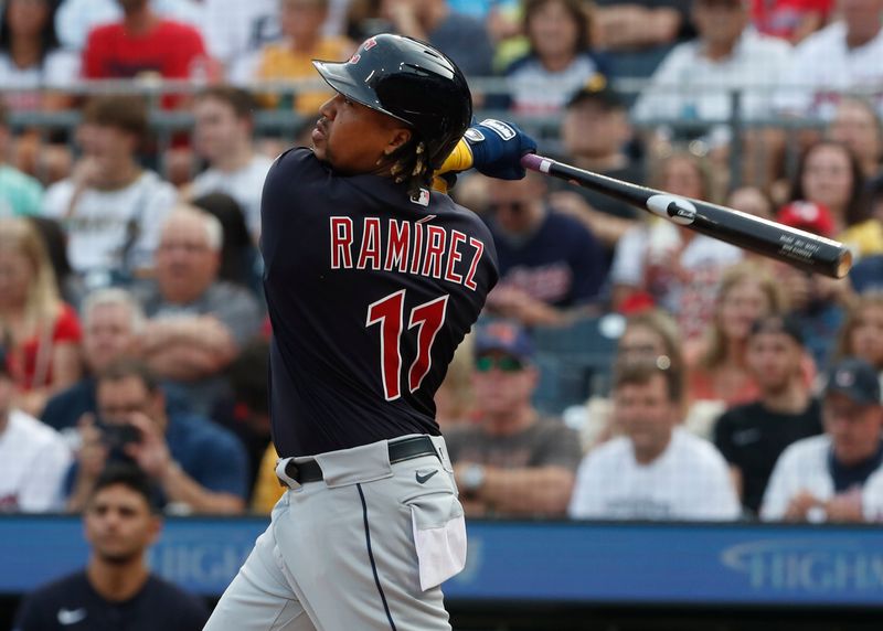 Jul 18, 2023; Pittsburgh, Pennsylvania, USA;  Cleveland Guardians third baseman Jose Ramirez (11) hits a single against the Pittsburgh Pirates during the first inning at PNC Park. Mandatory Credit: Charles LeClaire-USA TODAY Sports