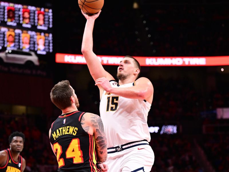 ATLANTA, GA - DECEMBER 8: Nikola Jokic #15 of the Denver Nuggets drives to the basket during the game against the Atlanta Hawks on December 8, 2024 at State Farm Arena in Atlanta, Georgia.  NOTE TO USER: User expressly acknowledges and agrees that, by downloading and/or using this Photograph, user is consenting to the terms and conditions of the Getty Images License Agreement. Mandatory Copyright Notice: Copyright 2024 NBAE (Photo by Adam Hagy/NBAE via Getty Images)