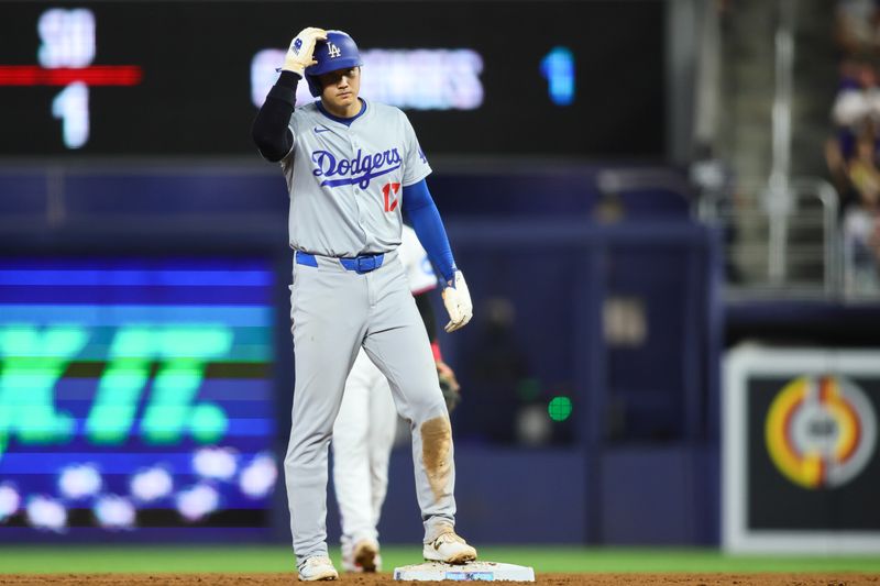 Sep 19, 2024; Miami, Florida, USA; Los Angeles Dodgers designated hitter Shohei Ohtani (17) looks on after stealing second base against the Miami Marlins during the second inning at loanDepot Park. Mandatory Credit: Sam Navarro-Imagn Images
