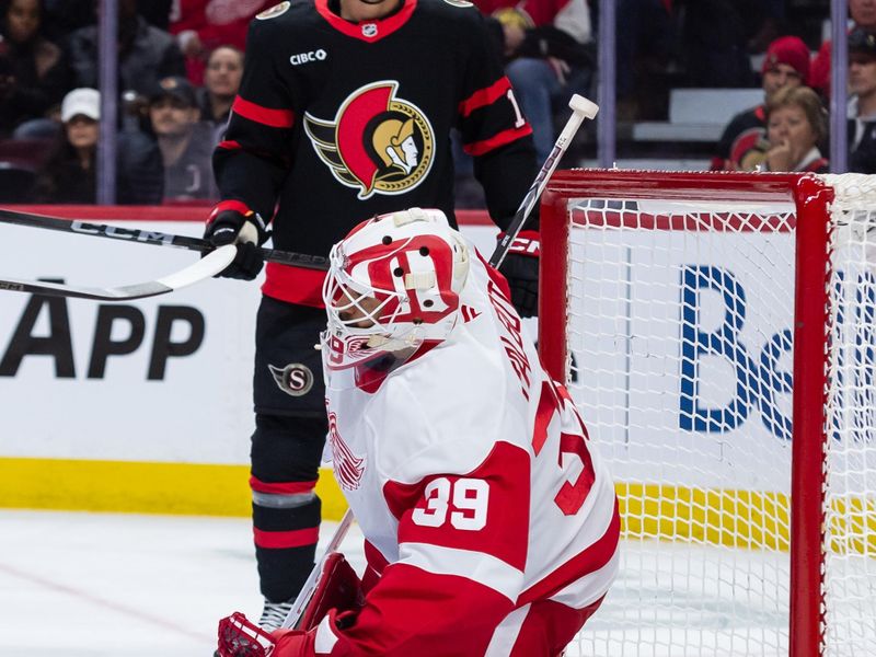 Mar 10, 2025; Ottawa, Ontario, CAN; Detroit Red Wings goalie Cameron Talbot (39) makes a save in front of  Ottawa Senators center Shane Pinot (12) in the first period at the Canadian Tire Centre. Mandatory Credit: Marc DesRosiers-Imagn Images