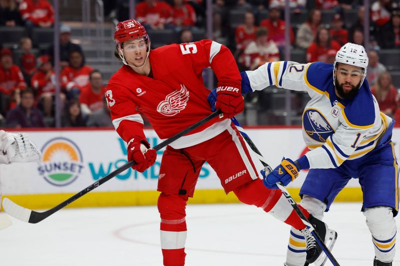 Apr 7, 2024; Detroit, Michigan, USA; Detroit Red Wings defenseman Moritz Seider (53) and Buffalo Sabres left wing Jordan Greenway (12) fight for position in the first period at Little Caesars Arena. Mandatory Credit: Rick Osentoski-USA TODAY Sports