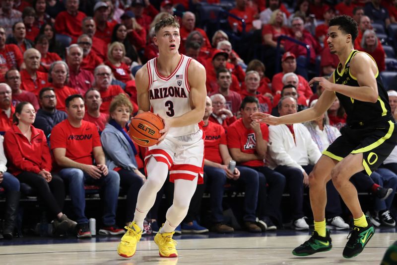 Feb 2, 2023; Tucson, Arizona, USA; Arizona Wildcats guard Pelle Larsson (3) makes a pass against Oregon Ducks guard Will Richardson (0) in the second half at McKale Center. Mandatory Credit: Zachary BonDurant-USA TODAY Sports