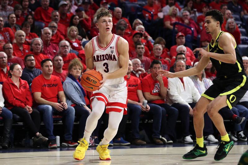 Feb 2, 2023; Tucson, Arizona, USA; Arizona Wildcats guard Pelle Larsson (3) makes a pass against Oregon Ducks guard Will Richardson (0) in the second half at McKale Center. Mandatory Credit: Zachary BonDurant-USA TODAY Sports