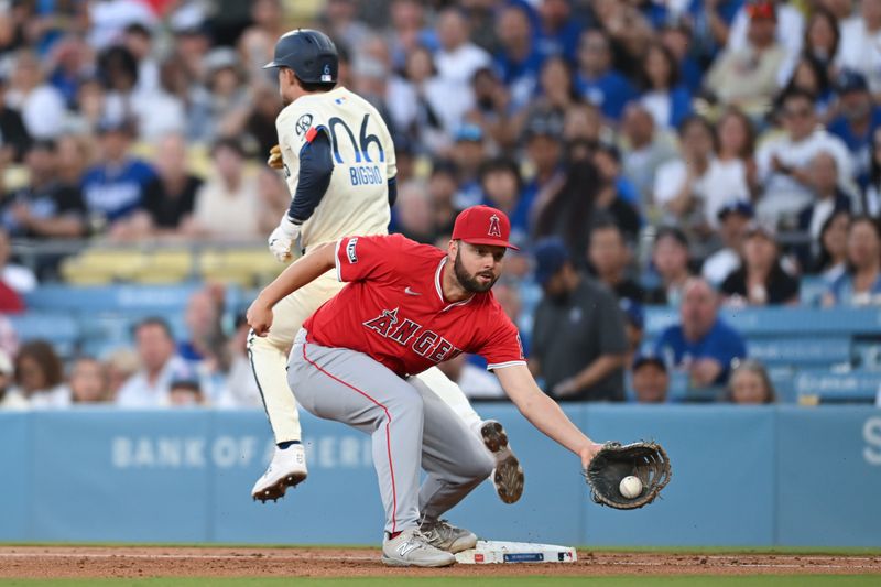 Jun 22, 2024; Los Angeles, California, USA; Los Angeles Dodgers third baseman Cavan Biggio (6) singles against Los Angeles Angels first baseman Nolan Schanuel (18) during the third inning at Dodger Stadium. Mandatory Credit: Jonathan Hui-USA TODAY Sports