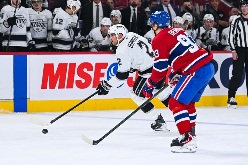 Nov 11, 2025; Montreal, Quebec, CAN; Los Angeles Kings defenseman Brian Dumoulin (2) plays the puck against Montreal Canadiens right wing Ivan Demidov (93) during the second period at Bell Centre. Mandatory Credit: David Kirouac-Imagn Images