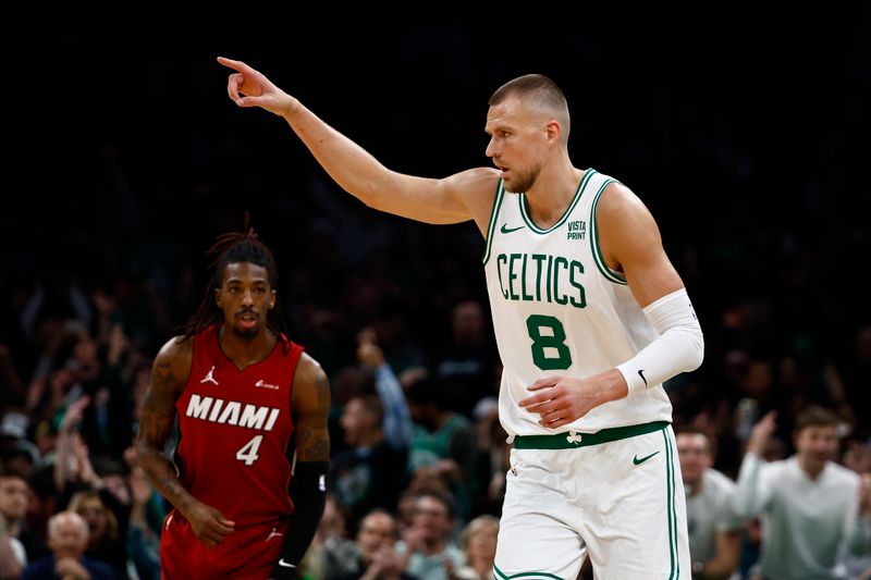 BOSTON, MA - APRIL 21: Kristaps Porzingis #8 of the Boston Celtics points to a teammate after making a three point basket as Delon Wright #4 of the Miami Heat looks on during the first quarter of game one of the Eastern Conference First Round Playoffs at TD Garden on April 21, 2024 in Boston, Massachusetts. NOTE TO USER: User expressly acknowledges and agrees that, by downloading and/or using this Photograph, user is consenting to the terms and conditions of the Getty Images License Agreement. (Photo By Winslow Townson/Getty Images)