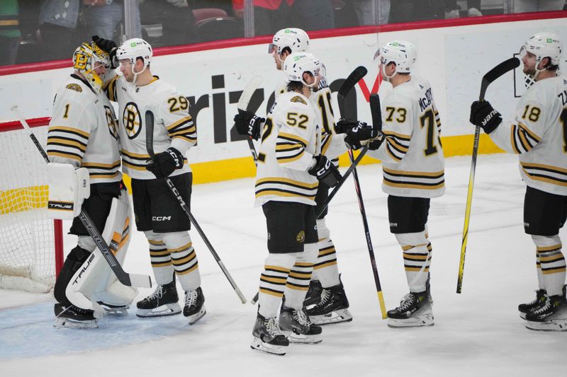 Mar 26, 2024; Sunrise, Florida, USA; Boston Bruins defenseman Parker Wotherspoon (29) congratulates goaltender Jeremy Swayman (1) on a victory over the Florida Panthers at Amerant Bank Arena. Mandatory Credit: Jim Rassol-USA TODAY Sports