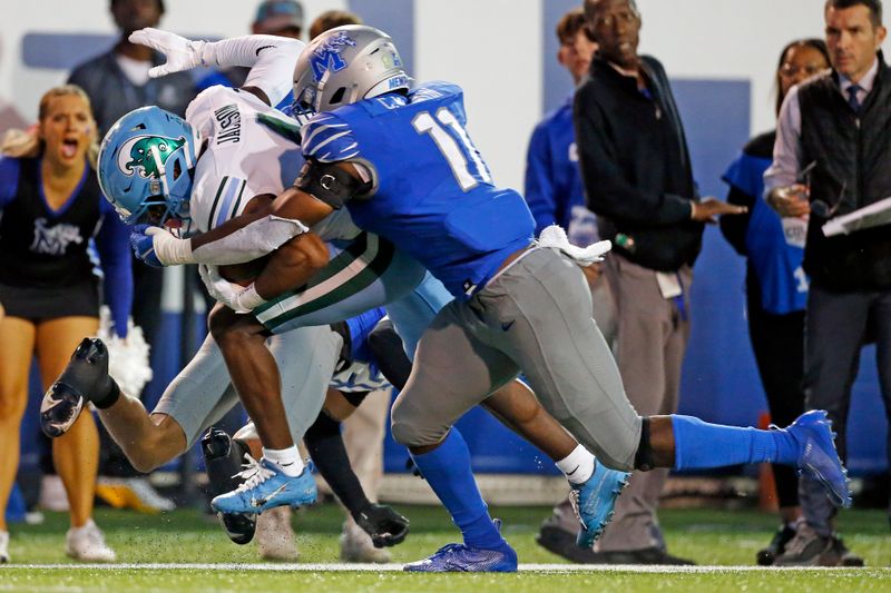 Oct 13, 2023; Memphis, Tennessee, USA; Tulane Green Wave wide receiver Jha'Quan Jackson (4) runs after a catch as Memphis Tigers defensive back Cameron Smith (29) and linebacker Chandler Martin (11) make the tackle during the first half at Simmons Bank Liberty Stadium. Mandatory Credit: Petre Thomas-USA TODAY Sports