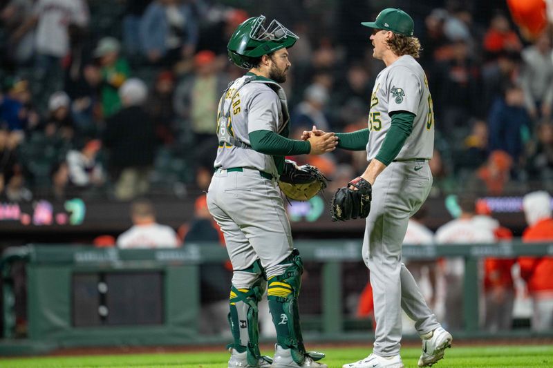 Jul 30, 2024; San Francisco, California, USA;  Oakland Athletics pitcher Tyler Ferguson (65) and Oakland Athletics catcher Shea Langeliers (23) celebrate after the game against the San Francisco Giants at Oracle Park. Mandatory Credit: Neville E. Guard-USA TODAY Sports