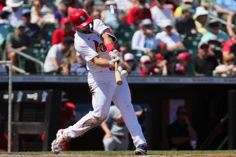 Mar 11, 2024; Jupiter, Florida, USA; St. Louis Cardinals first baseman Paul Goldschmidt (46) hits an RBI double against the Washington Nationals during the fourth inning at Roger Dean Chevrolet Stadium. Mandatory Credit: Sam Navarro-USA TODAY Sports