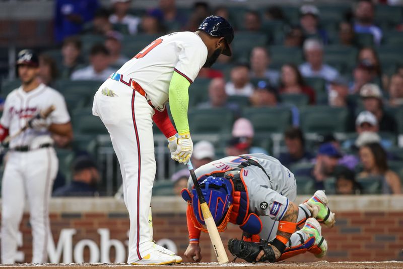 Sep 24, 2024; Atlanta, Georgia, USA; New York Mets catcher Francisco Alvarez (4) reacts after being hit by the bat of Atlanta Braves designated hitter Marcell Ozuna (20) in the first inning at Truist Park. Mandatory Credit: Brett Davis-Imagn Images