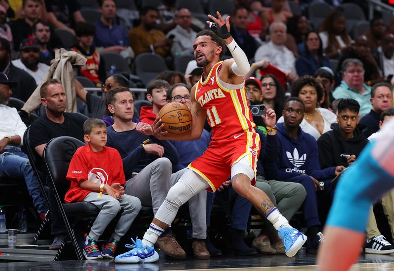 ATLANTA, GEORGIA - APRIL 10:  Trae Young #11 of the Atlanta Hawks reacts as he draws a foul from the Charlotte Hornets during the second quarter at State Farm Arena on April 10, 2024 in Atlanta, Georgia.  NOTE TO USER: User expressly acknowledges and agrees that, by downloading and/or using this photograph, user is consenting to the terms and conditions of the Getty Images License Agreement.  (Photo by Kevin C. Cox/Getty Images)