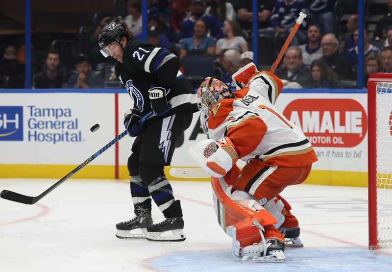 Oct 25, 2025; Tampa, Florida, USA;Tampa Bay Lightning center Brayden Point (21) skates with the puck as Anaheim Ducks goaltender Lukas Dostal (1) defends during the third period at Benchmark International Arena. Mandatory Credit: Kim Klement Neitzel-Imagn Images
