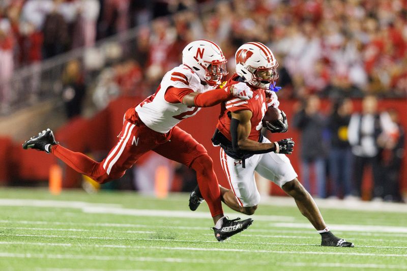 Nov 18, 2023; Madison, Wisconsin, USA;  Wisconsin Badgers wide receiver Will Pauling (6) is tackled by Nebraska Cornhuskers defensive back Marques Buford Jr. (24) after catching a pass during the third quarter at Camp Randall Stadium. Mandatory Credit: Jeff Hanisch-USA TODAY Sports