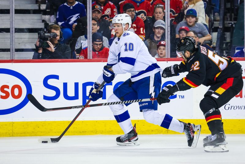 Jan 21, 2023; Calgary, Alberta, CAN; Tampa Bay Lightning right wing Corey Perry (10) controls the puck against Calgary Flames defenseman MacKenzie Weegar (52) during the third period at Scotiabank Saddledome. Mandatory Credit: Sergei Belski-USA TODAY Sports