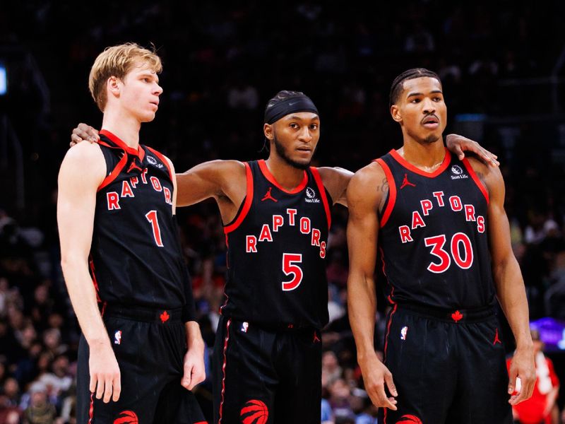 TORONTO, CANADA - JANUARY 3: Immanuel Quickley #5 of the Toronto Raptors wraps his arms around Gradey Dick #1 and Ochai Agbaji #30 during first half of their NBA game against the Orlando Magic at Scotiabank Arena on January 3, 2025 in Toronto, Canada. NOTE TO USER: User expressly acknowledges and agrees that, by downloading and or using this photograph, User is consenting to the terms and conditions of the Getty Images License Agreement. (Photo by Cole Burston/Getty Images)