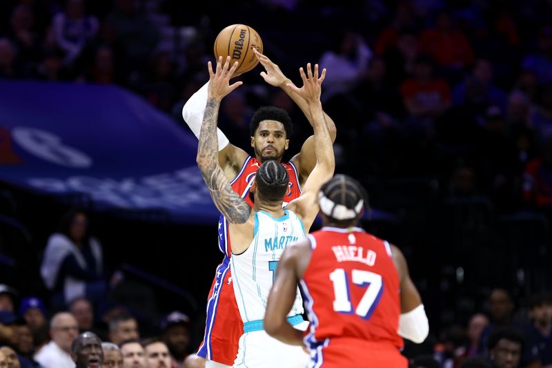 PHILADELPHIA, PENNSYLVANIA - MARCH 01: Tobias Harris #12 passes to Buddy Hield #17 of the Philadelphia 76ers over Cody Martin #11 of the Charlotte Hornets during the second quarter at the Wells Fargo Center on March 01, 2024 in Philadelphia, Pennsylvania. NOTE TO USER: User expressly acknowledges and agrees that, by downloading and or using this photograph, User is consenting to the terms and conditions of the Getty Images License Agreement.  (Photo by Tim Nwachukwu/Getty Images)