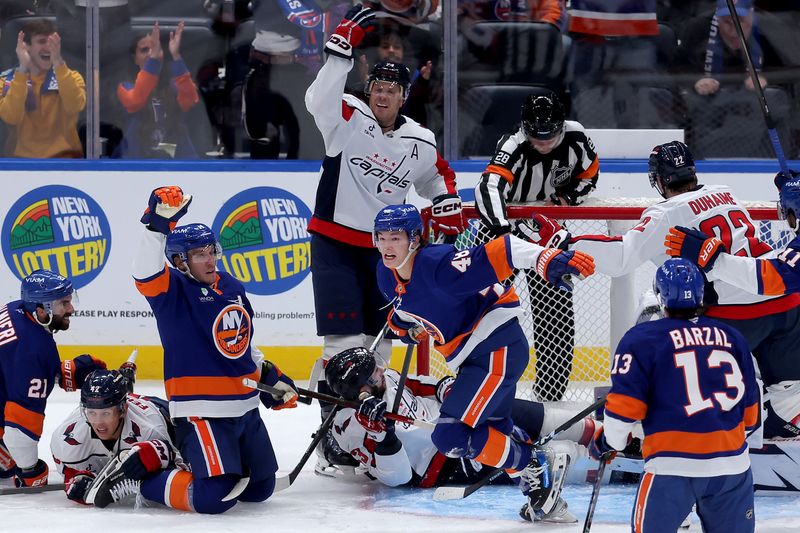 Oct 11, 2025; Elmont, New York, USA; New York Islanders defenseman Matthew Schaefer (48) celebrates his goal against the Washington Capitals during the third period at UBS Arena. The goal was the first of his NHL career. Mandatory Credit: Brad Penner-Imagn Images