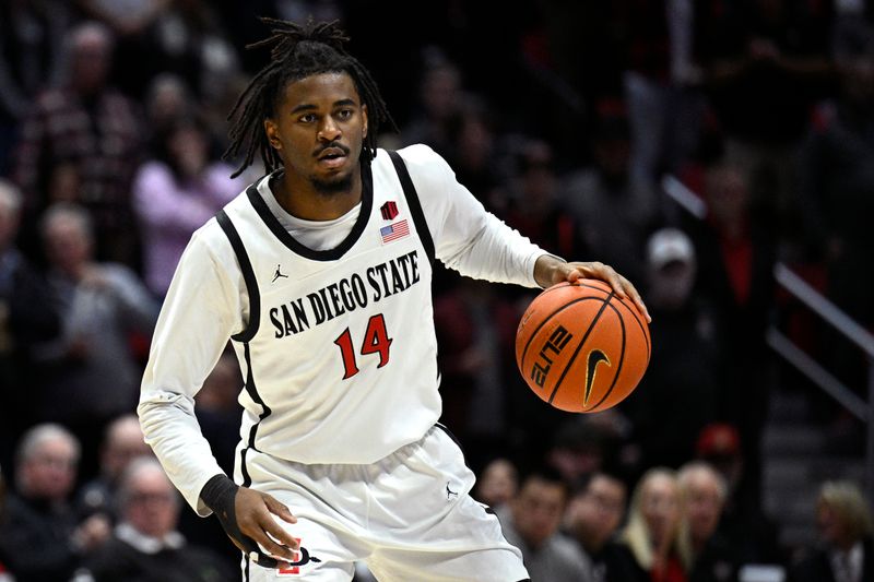 Nov 27, 2023; San Diego, California, USA; San Diego State Aztecs guard Reese Waters (14) dribbles the ball during the first half against the Point Loma Nazarene Sea Lions at Viejas Arena. Mandatory Credit: Orlando Ramirez-USA TODAY Sports