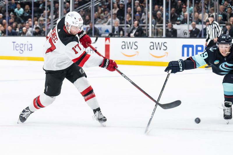 Dec 7, 2023; Seattle, Washington, USA; New Jersey Devils defenseman Simon Nemec (17) takes a shot against defenseman Vince Dunn (29) during the first period at Climate Pledge Arena. Mandatory Credit: Stephen Brashear-USA TODAY Sports