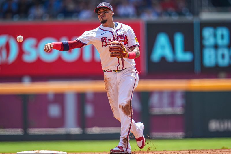 Jun 30, 2024; Cumberland, Georgia, USA; Atlanta Braves shortstop Orlando Arcia (11) throws out Pittsburgh Pirates center fielder Jack Suwinski (65) (not shown) after fielding a ground ball during the second inning at Truist Park. Mandatory Credit: Dale Zanine-USA TODAY Sports