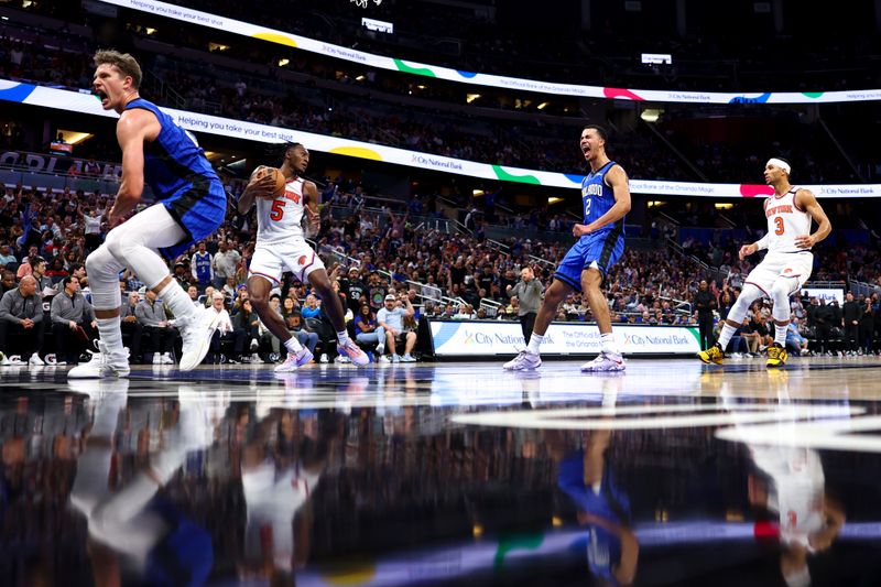 ORLANDO, FLORIDA - MARCH 23: Moritz Wagner #21 and Caleb Houstan #2 of the Orlando Magic react against the New York Knicks during the fourth quarter at Amway Center on March 23, 2023 in Orlando, Florida. NOTE TO USER: User expressly acknowledges and agrees that, by downloading and or using this photograph, User is consenting to the terms and conditions of the Getty Images License Agreement. (Photo by Douglas P. DeFelice/Getty Images)