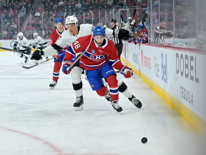 Oct 17, 2024; Montreal, Quebec, CAN; Los Angeles Kings forward Andre Lee (47) and Montreal Canadiens defenseman Lane Hutson (48) chase the puck during the first period at the Bell Centre. Mandatory Credit: Eric Bolte-Imagn Images