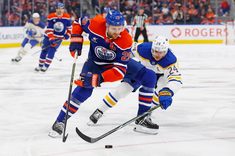 Jan 25, 2025; Edmonton, Alberta, CAN; Edmonton Oilers forward Leon Draisaitl (29) protects the puck from Buffalo Sabres forward Dylan Cozens (24) during the second period at Rogers Place. Mandatory Credit: Perry Nelson-Imagn Images