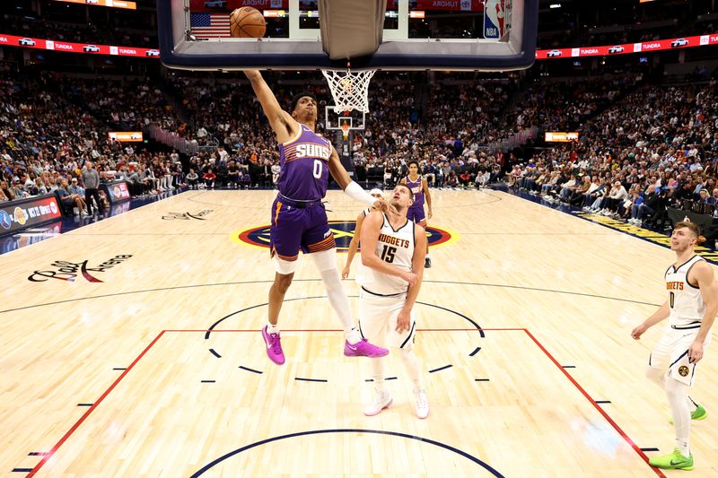 DENVER, COLORADO - OCTOBER 13: Ryan Dunn #0 of the Phoenix Suns dunks against the Denver Nuggets in the first half at Ball Arena on October 13, 2024 in Denver, Colorado. NOTE TO USER: User expressly acknowledges and agrees that, by downloading and/or using this Photograph, user is consenting to the terms and conditions of the Getty Images License Agreement. (Photo by Jamie Schwaberow/Getty Images)