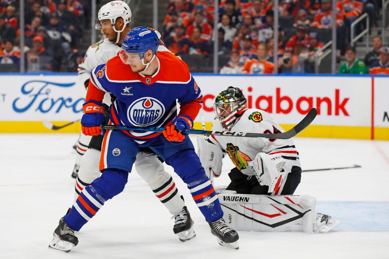 Oct 12, 2024; Edmonton, Alberta, CAN; Edmonton Oilers forward Vasily Podkolzin (92) battles with Chicago Blackhawks defensemen Seth Jones (4) in front of goaltender Petr Mrazek (34) during the third period at Rogers Place. Mandatory Credit: Perry Nelson-Imagn Images