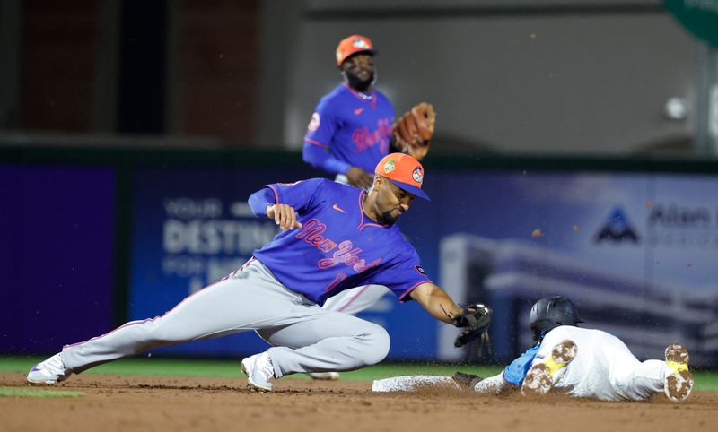 Mar 6, 2026; Jupiter, Florida, USA;  New York Mets second baseman Marcus Semien (10) tags out Miami Marlins shortstop Maximo Acosta (24) as he tries to steal second base during the second inning at Roger Dean Chevrolet Stadium. Mandatory Credit: Rhona Wise-Imagn Images