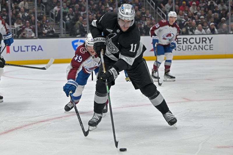 Oct 7, 2025; Los Angeles, California, USA;  Los Angeles Kings center Anze Kopitar (11) controls the puck during the second period against the Colorado Avalanche at Crypto.com Arena. Mandatory Credit: Jayne Kamin-Oncea-Imagn Images