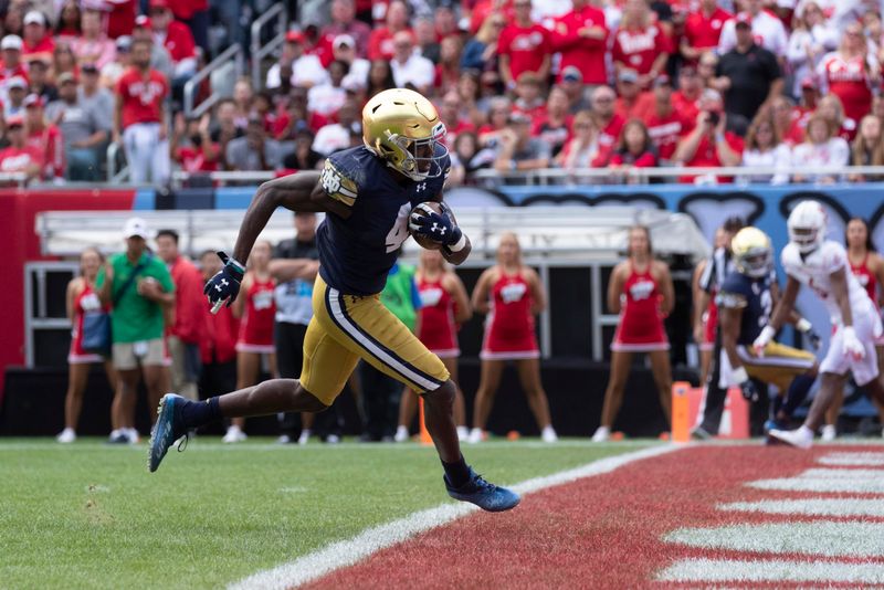 Sep 25, 2021; Chicago, IL, USA;  Notre Dame wide receiver Kevin Austin Jr. (4) scores a touchdown on a 16-yard reception during there fourth  quarter of their game Saturday, September 25, 2021 at Soldier Field in Chicago, Ill. Notre Dame beat Wisconsin 41-13. Mandatory Credit: Mark Hoffman-USA TODAY Sports