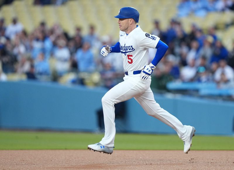 Apr 29, 2025; Los Angeles, California, USA; Los Angeles Dodgers first baseman Freddie Freeman (5) doubles during the first inning against the Miami Marlins at Dodger Stadium. Mandatory Credit: Kirby Lee-Imagn Images