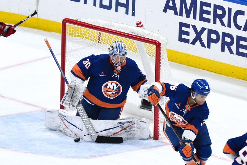 Nov 9, 2024; Elmont, New York, USA; New York Islanders goaltender Ilya Sorokin (30) makes a save against the New Jersey Devils during the first period at UBS Arena. Mandatory Credit: John Jones-Imagn Images