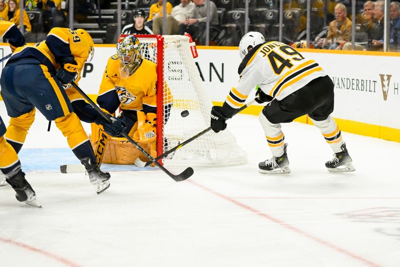 Oct 22, 2024; Nashville, Tennessee, USA;  Nashville Predators goaltender Juuse Saros (74) and defenseman Roman Josi (59) block the shot of Boston Bruins left wing Max Jones (49) during the second period at Bridgestone Arena. Mandatory Credit: Steve Roberts-Imagn Images