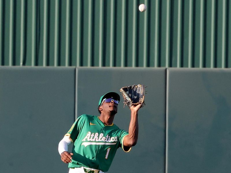 Jun 3, 2025; West Sacramento, California, USA; Athletics center fielder Denzel Clarke (1) catches a fly ball against the Minnesota Twins during the first inning at Sutter Health Park. Mandatory Credit: Dennis Lee-Imagn Images