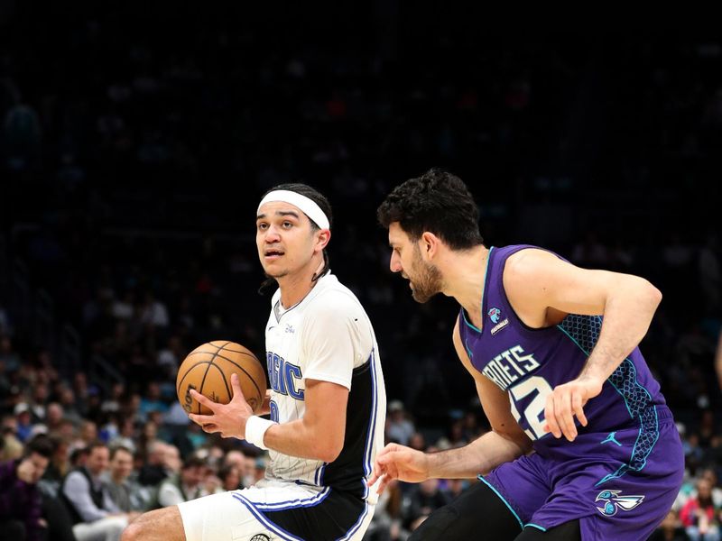 CHARLOTTE, NC - MARCH 5: Anthony Black #0 of the Orlando Magic handles the ball during the game against the Charlotte Hornets on March 5, 2024 at Spectrum Center in Charlotte, North Carolina. NOTE TO USER: User expressly acknowledges and agrees that, by downloading and or using this photograph, User is consenting to the terms and conditions of the Getty Images License Agreement.  Mandatory Copyright Notice:  Copyright 2024 NBAE (Photo by Brock Williams-Smith/NBAE via Getty Images)