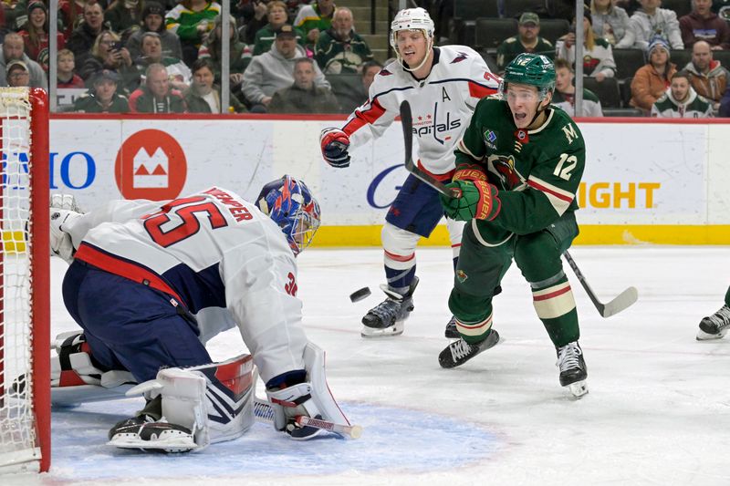 Jan 23, 2024; Saint Paul, Minnesota, USA;  Minnesota Wild forward Matt Boldy (12) shoots the puck wide of the net of Washington Capitals goalie Darcy Kuemper (35) during the second period at Xcel Energy Center. Mandatory Credit: Nick Wosika-USA TODAY Sports