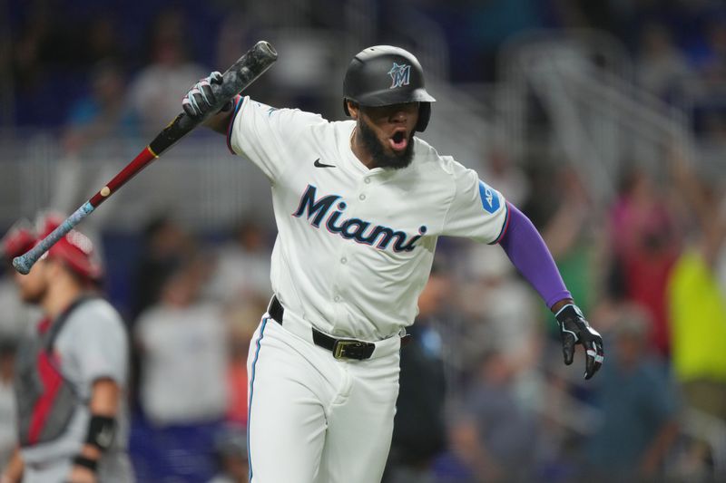 Jun 17, 2024; Miami, Florida, USA;  Miami Marlins designated hitter Bryan De La Cruz (14) reacts to hitting a three-run home run against the St. Louis Cardinals in the eighth inning at loanDepot Park. Mandatory Credit: Jim Rassol-USA TODAY Sports