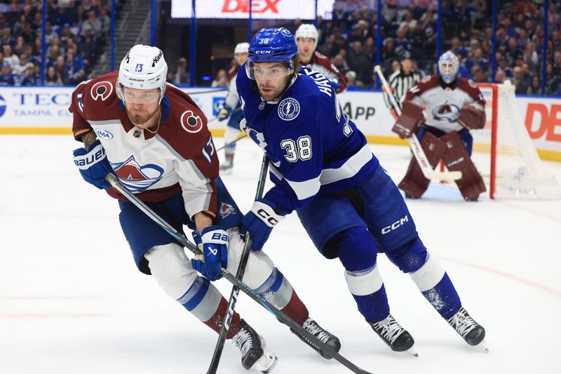Jan 6, 2026; Tampa, Florida, USA; Colorado Avalanche right wing Valeri Nichushkin (13) and Tampa Bay Lightning left wing Brandon Hagel (38) skate after the puck during the third period at Benchmark International Arena. Mandatory Credit: Kim Klement Neitzel-Imagn Images