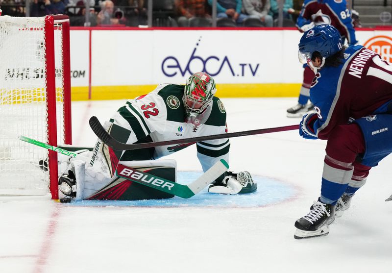 Sep 27, 2022; Denver, Colorado, USA; Minnesota Wild goaltender Filip Gustavsson (32) makes a save on Colorado Avalanche center Alex Newhook (18) in the second period at Ball Arena. Mandatory Credit: Ron Chenoy-USA TODAY Sports