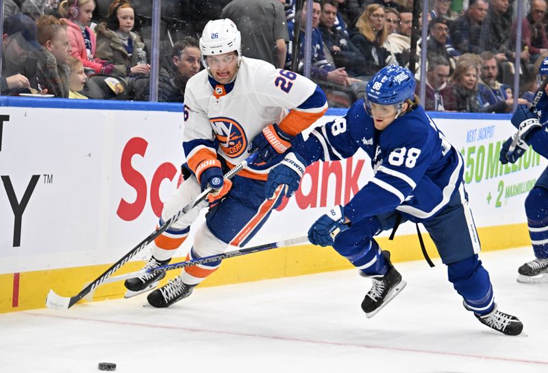 Feb 5, 2024; Toronto, Ontario, CAN;   New York Islanders forward Oliver Wahlstrom (26) passes the puck away from Toronto Maple Leafs forward William Nylander (88) in the first period at Scotiabank Arena. Mandatory Credit: Dan Hamilton-USA TODAY Sports