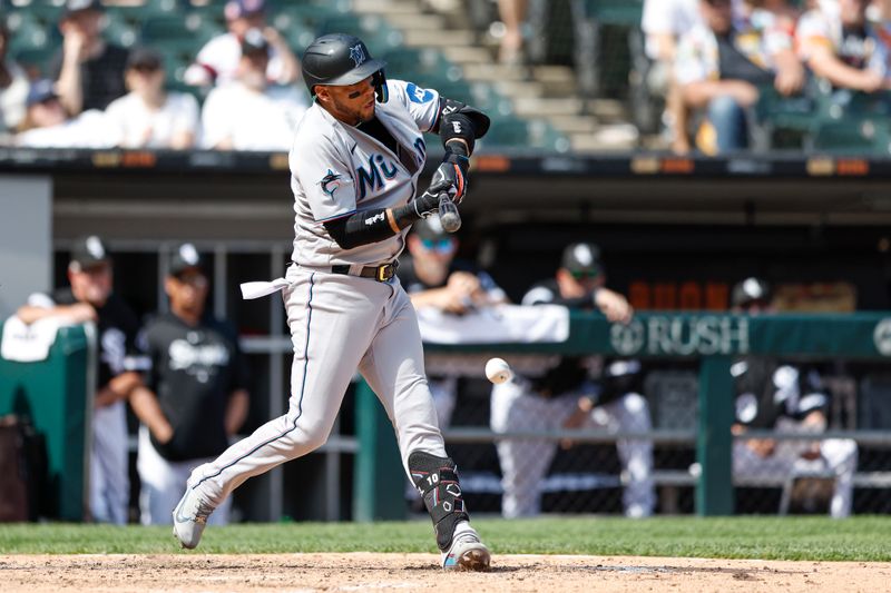 Jun 10, 2023; Chicago, Illinois, USA; Miami Marlins first baseman Yuli Gurriel (10) hits a RBI single against the Chicago White Sox during the ninth inning at Guaranteed Rate Field. Mandatory Credit: Kamil Krzaczynski-USA TODAY Sports